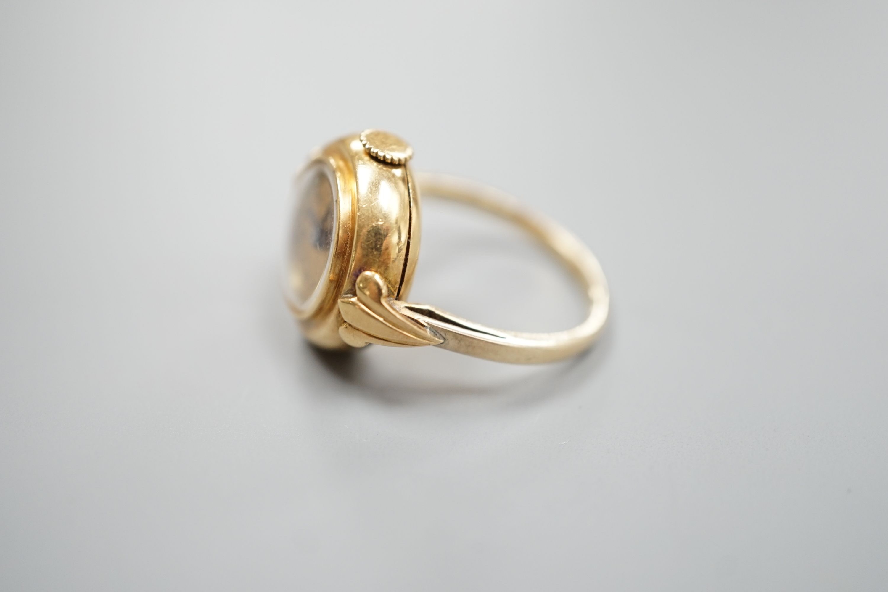 A yellow metal ring watch, the dial inscribed 'Van Cleef & Arpels', size N/O, gross 8.2 grams.